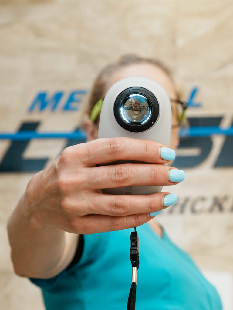 Hand with dermoscope